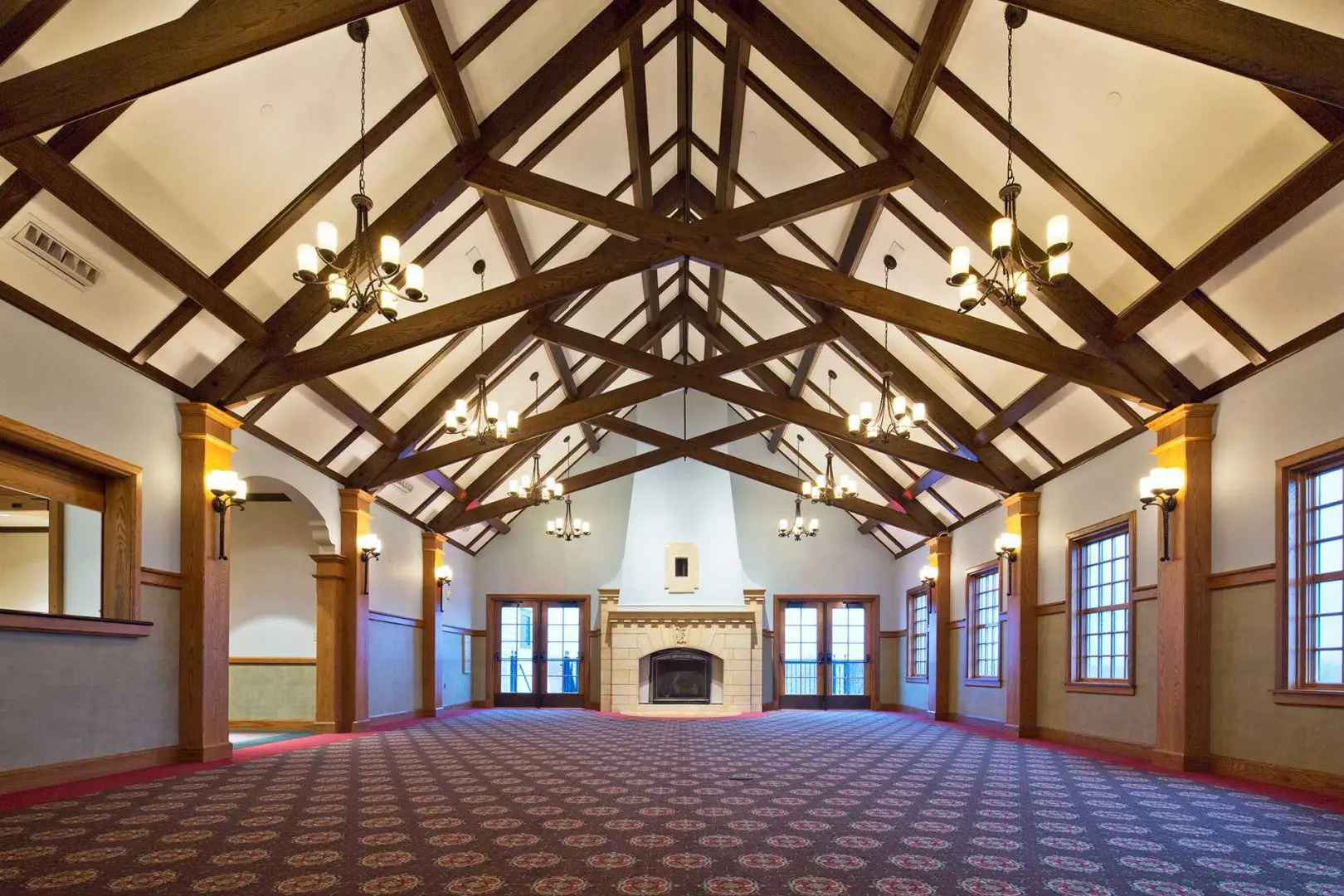 Empty room shot of ceiling beams and fireplace