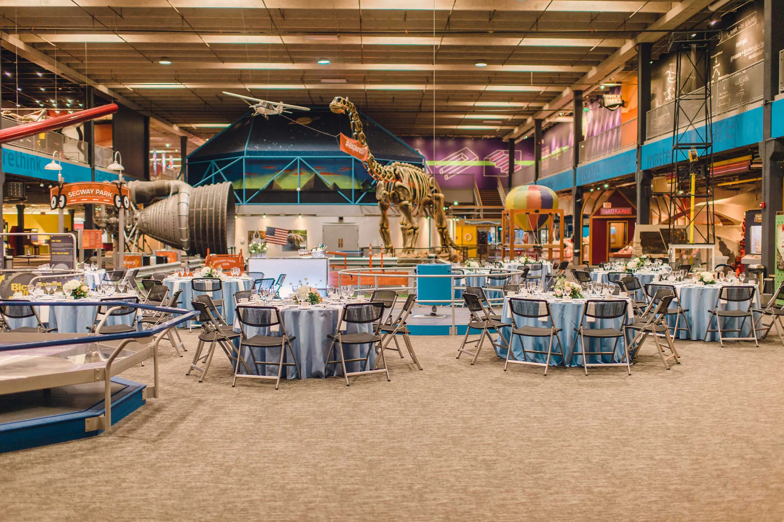 Wide shot of events tables over looking museum exhibit