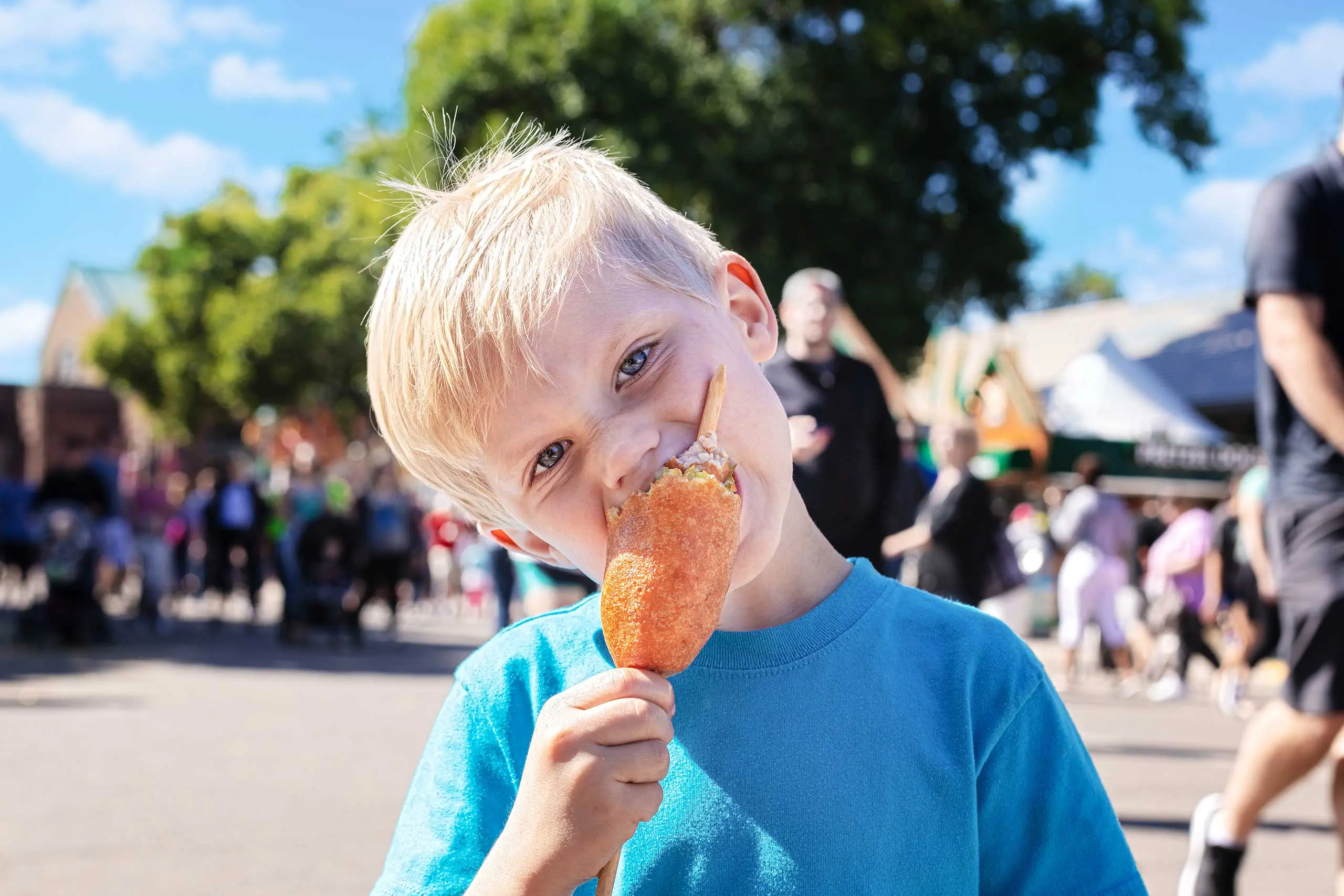 Child eating dilly dog