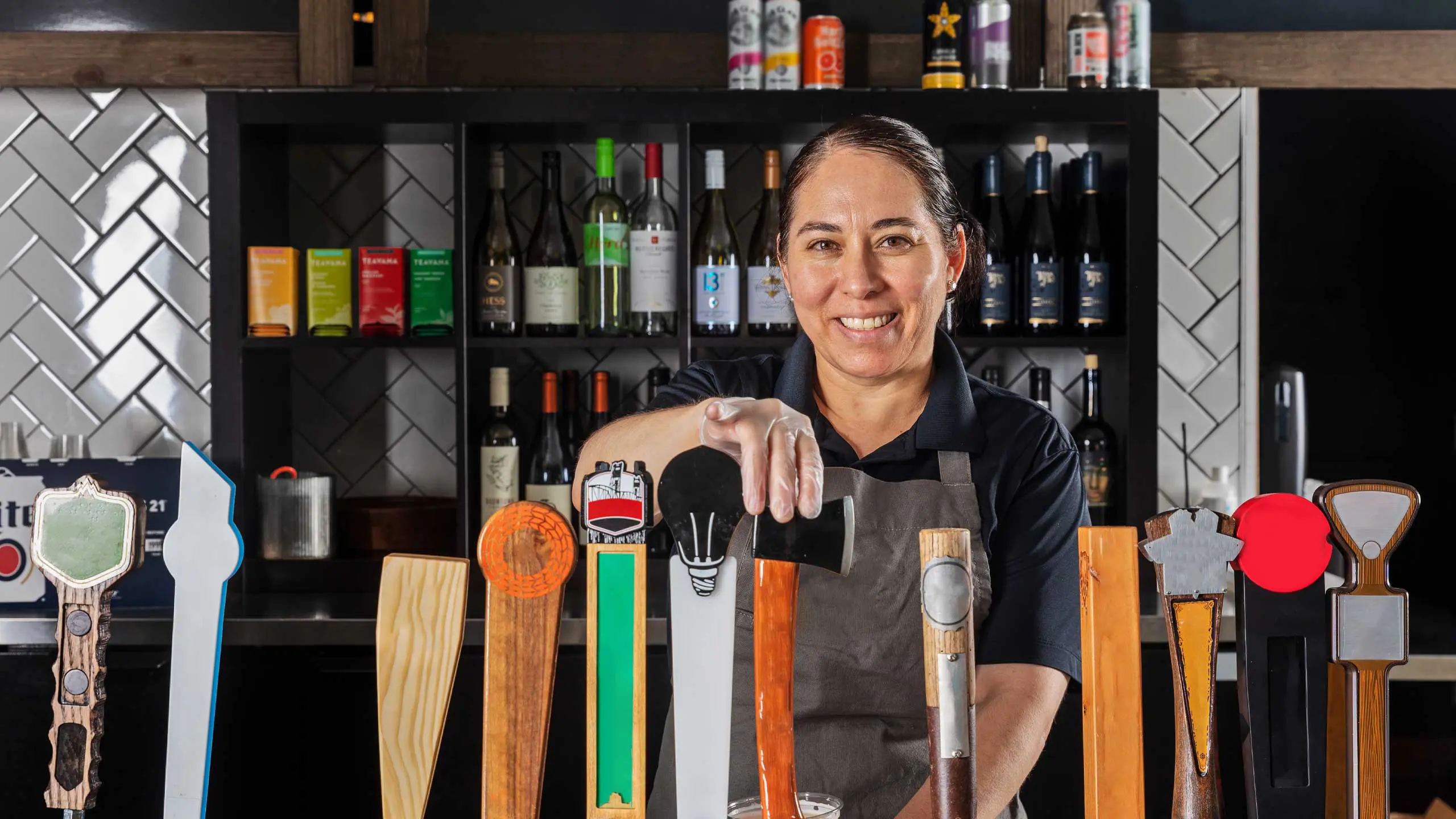 Bartender smiling and pouring beer from tap