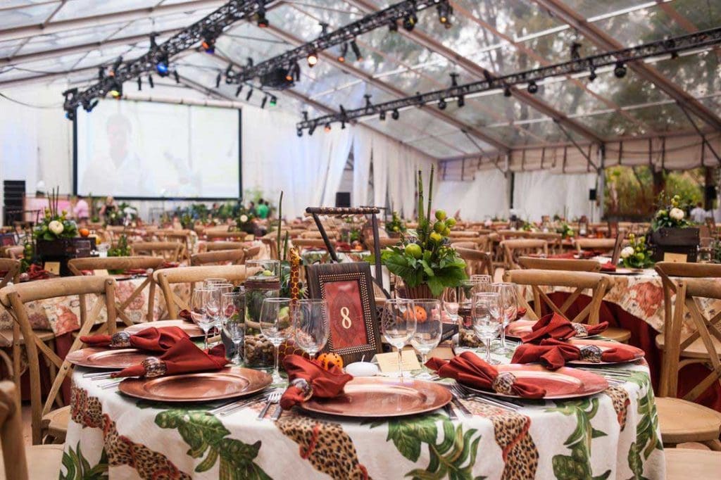 Table settings for event underneath large tent