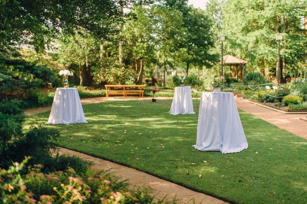 Cocktail tables with white linen on lawn