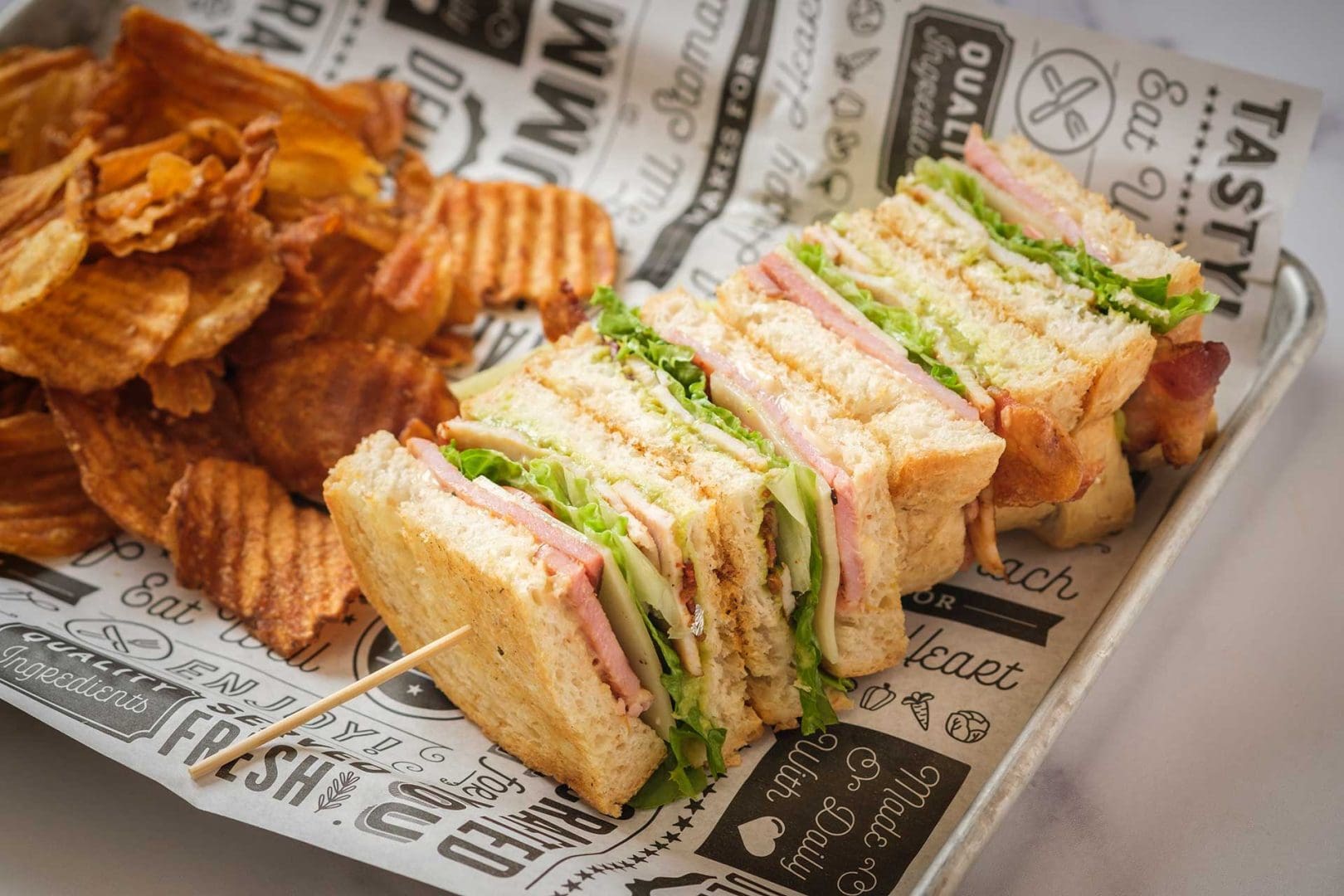 Close up shot of club sandwich with chips
